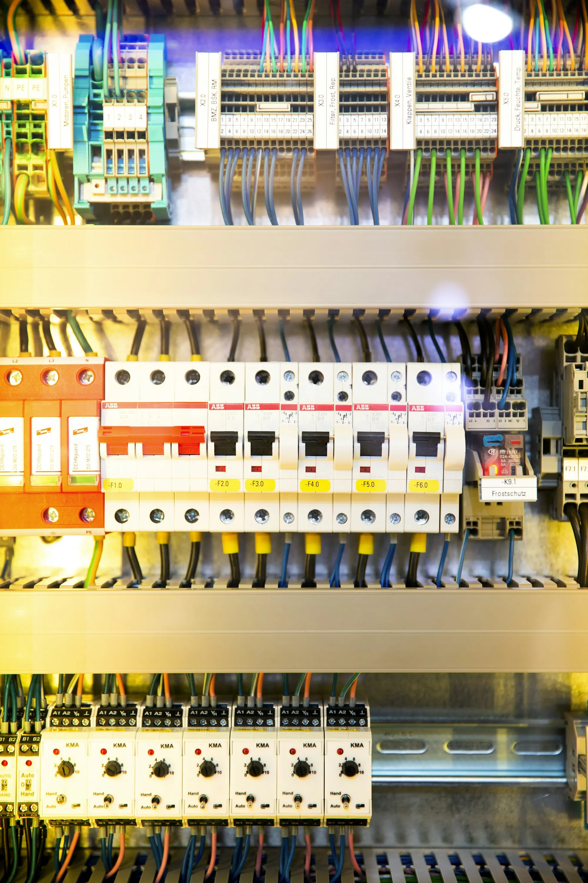 Open breaker panel with neatly routed coloured circuit wiring