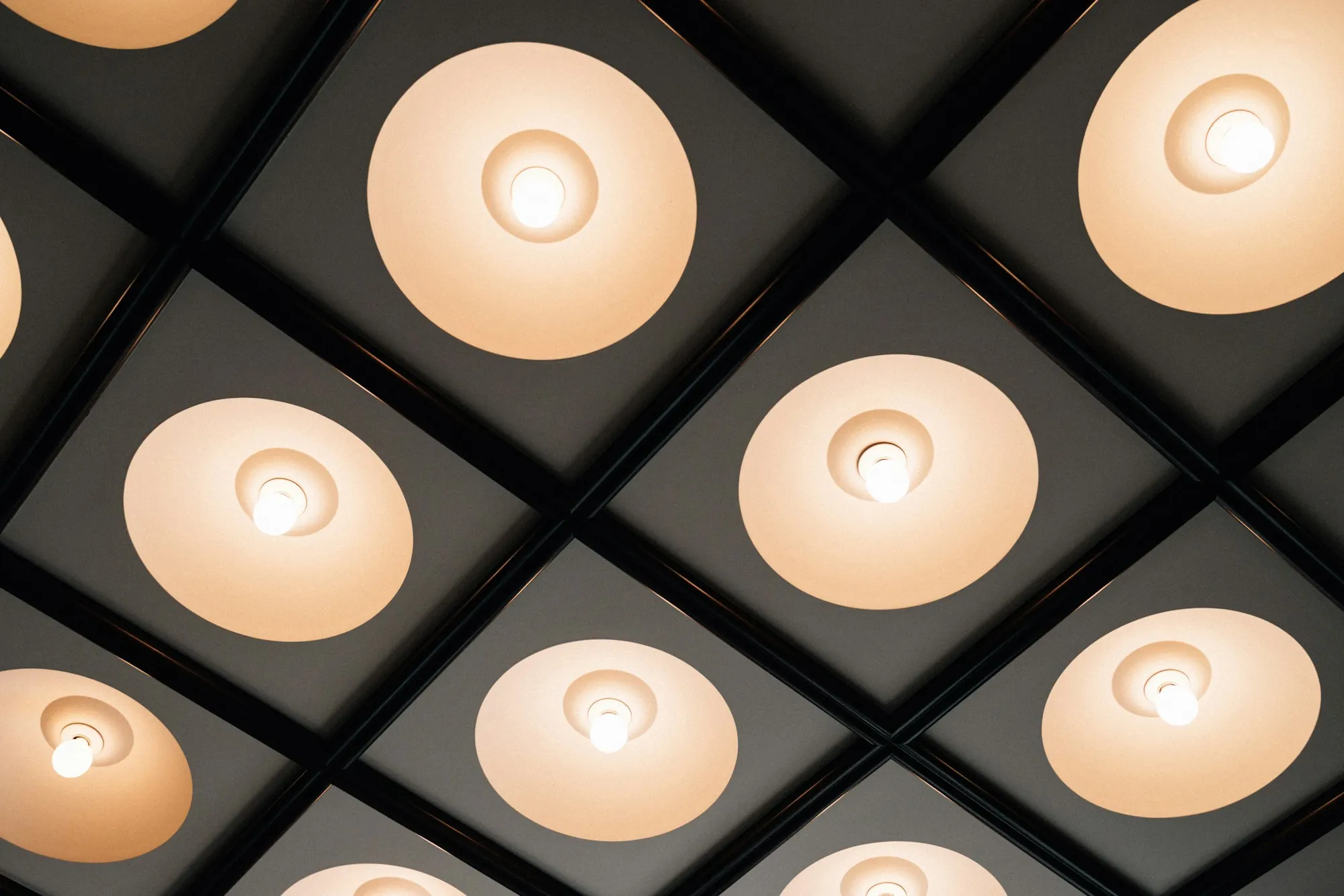 Recessed ceiling lights casting warm light across a modern interior