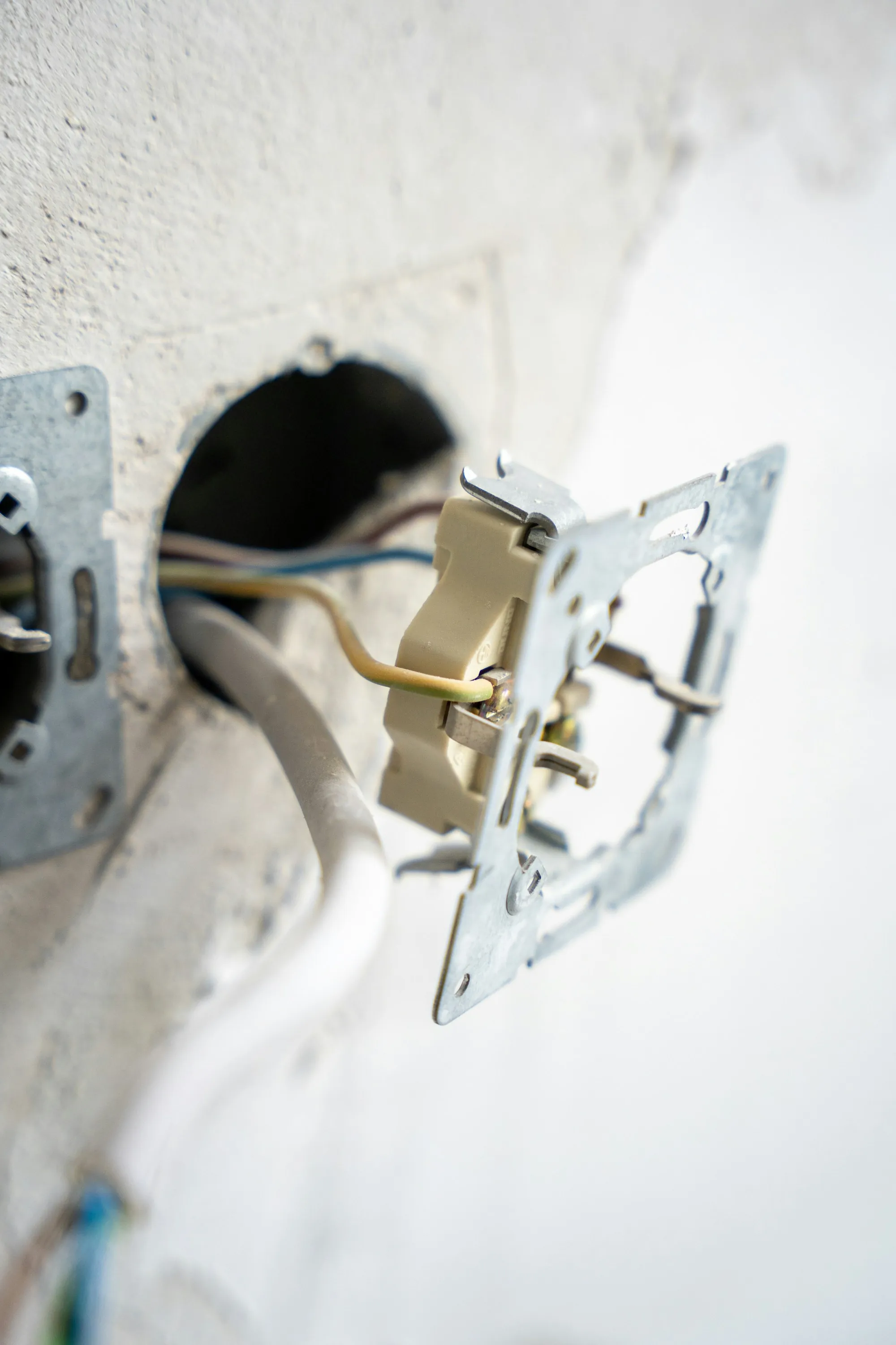 Exposed electrical cable runs inside an opened interior wall